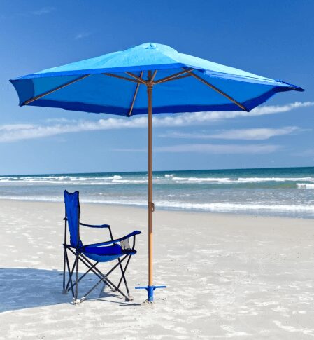 A blue umbrella and chair on the beach