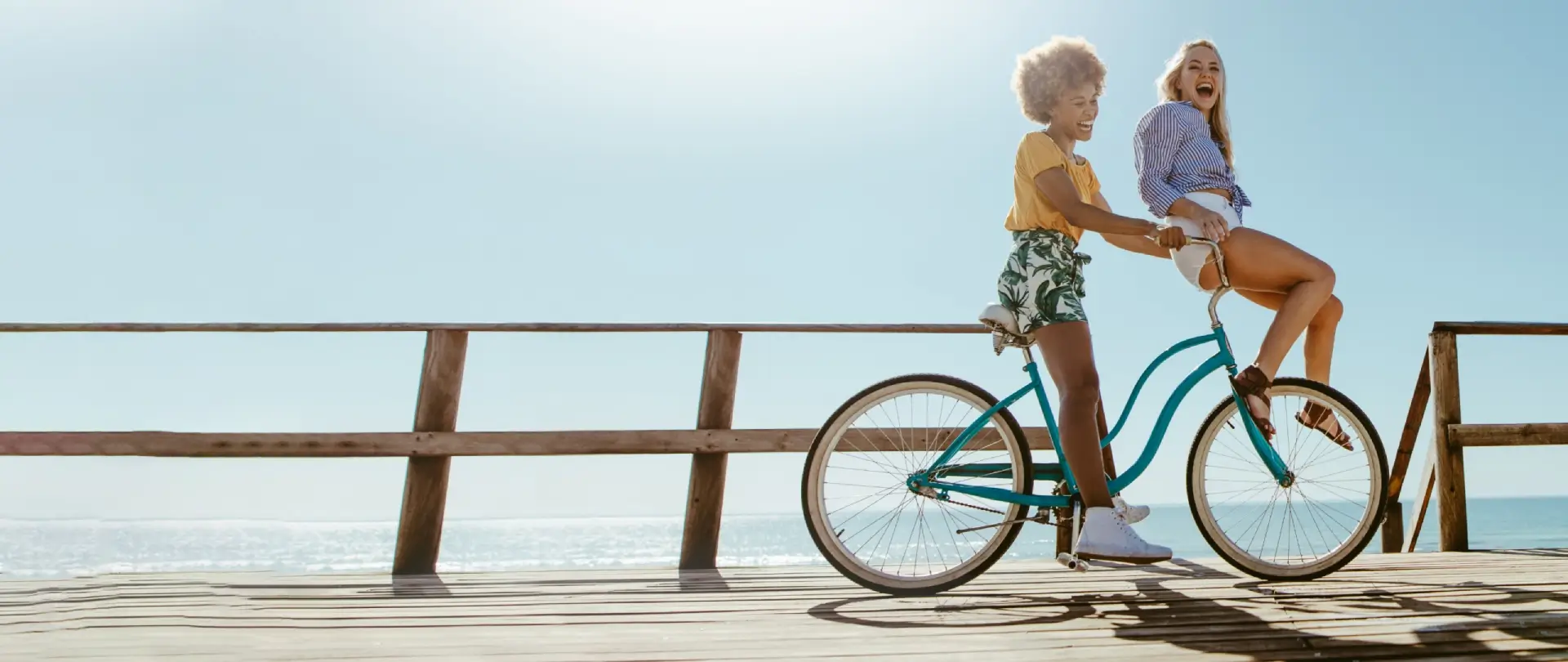 A woman riding on the back of a bicycle.