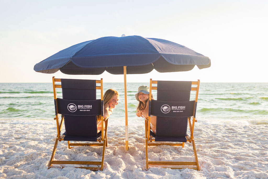 Two people relaxing on beach chairs.